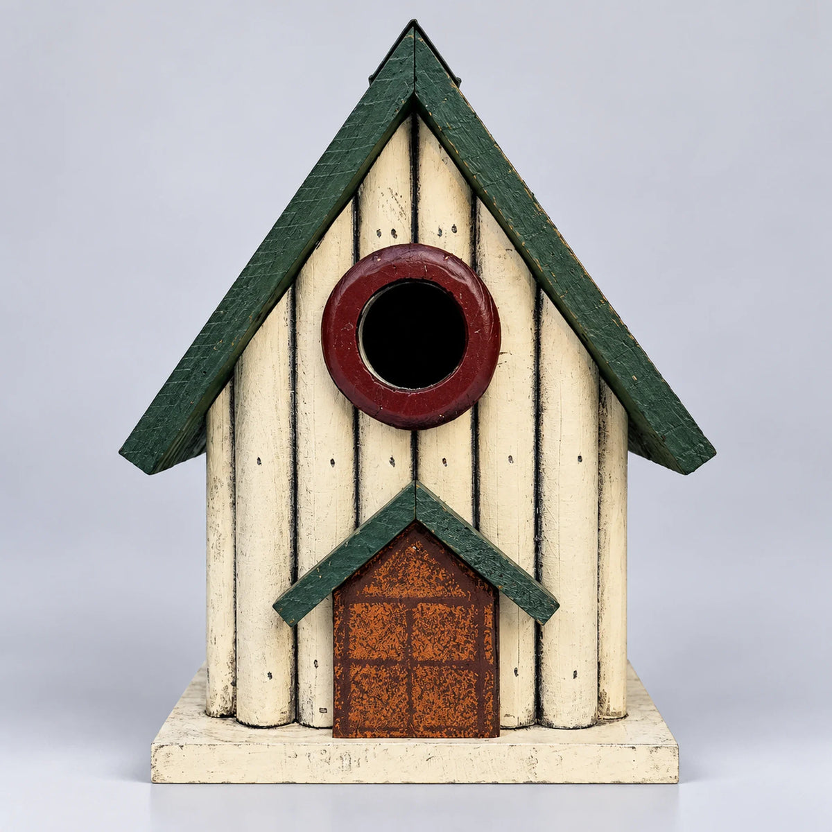 Small cream wooden birdhouse with green roof and red door